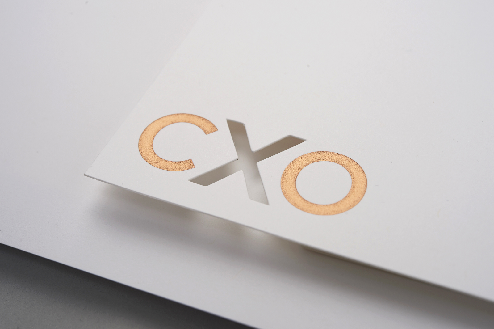 CXO logo die-cut and engraved showing a textural elegant brand design